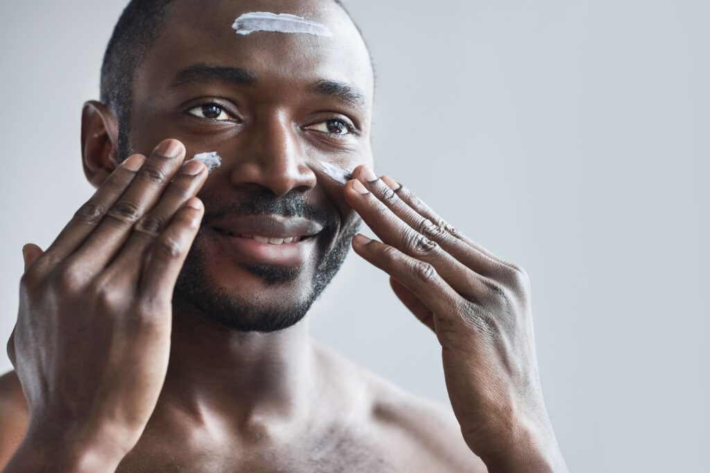 Man putting on sunscreen