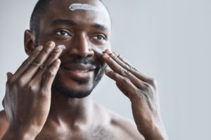 Man putting on sunscreen